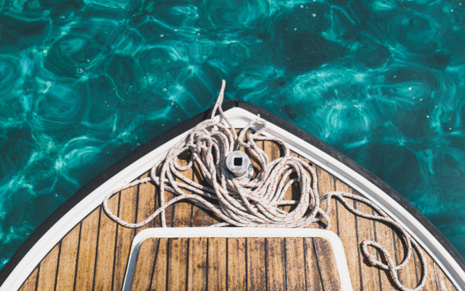 A birds eye view of the bow of a boat covered in rope.